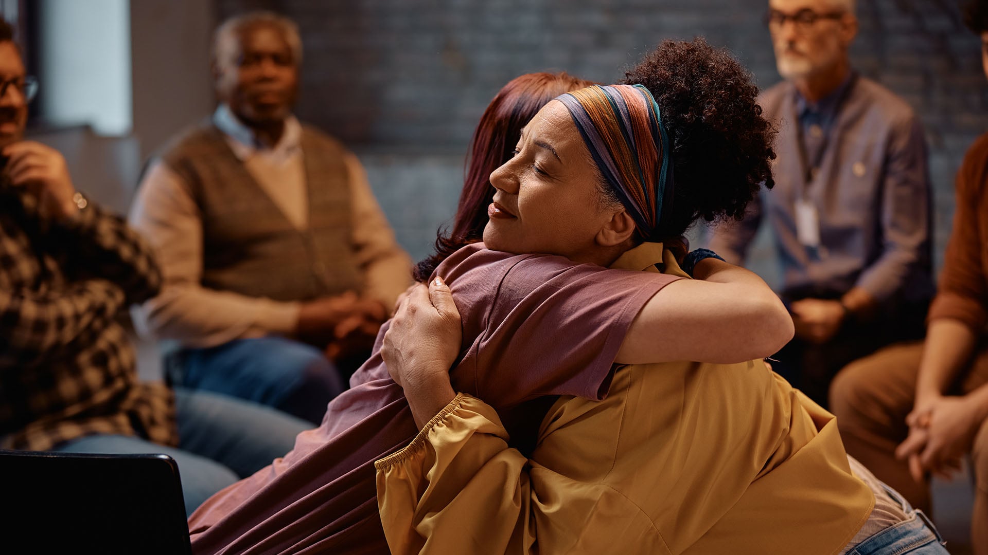 Peer support group participants sharing encouragement and connection during a mental health recovery program. Peer support group participants sharing encouragement and connection during a mental health recovery program.