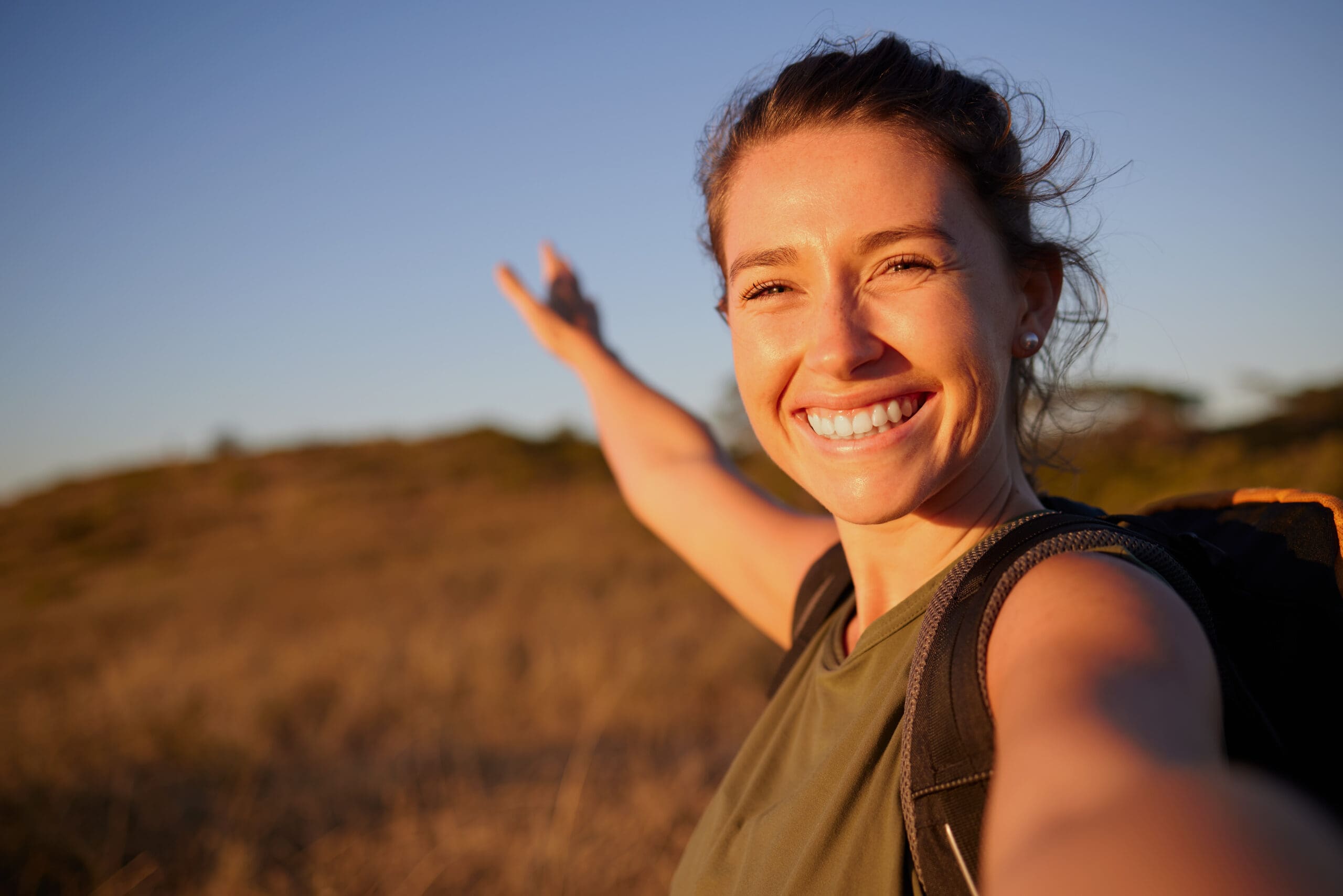 Woman enjoying time outdoors and embracing emotional wellness, resilience, and positive mental health.